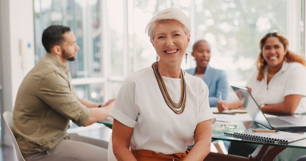 Elderly business woman, management and smile for team meeting eligible for a membership application